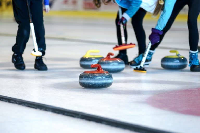 The rules of curling include curling stones and brushes as shown here