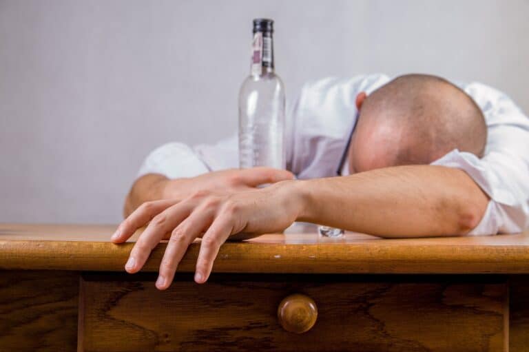 This hungover man is increasing his chances of experiencing the link between alcohol and cancer