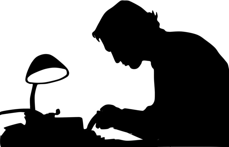 The shadow of a man typing, bringing to mind some inspiring quotes about writing