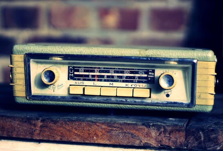 A vintage car radio playing NPR, raising the question, How is NPR funded?
