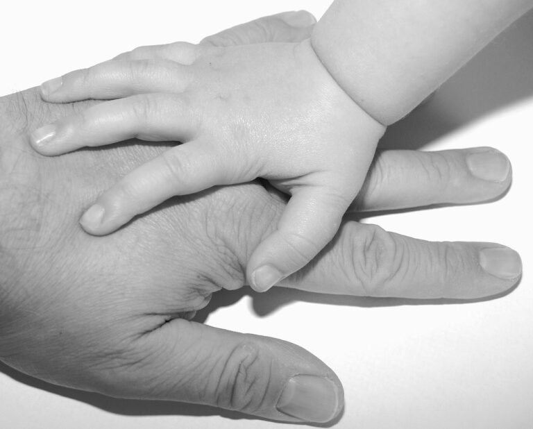 A daughter with her hand on her father's hand