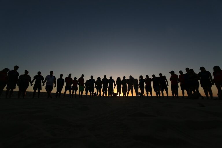 A group of people exhibiting tribalism at dusk