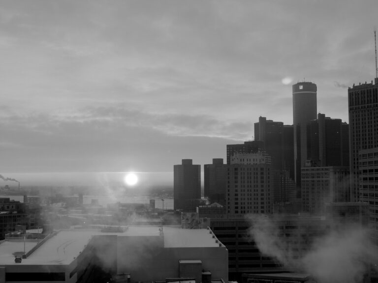 A black and white picture of downtown Detroit and the Detroit River