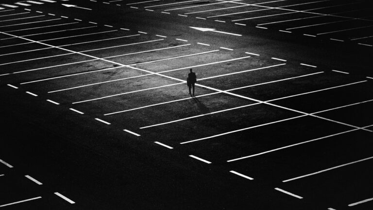 A man in an empty parking lot realizing he isn't a doctor anymore