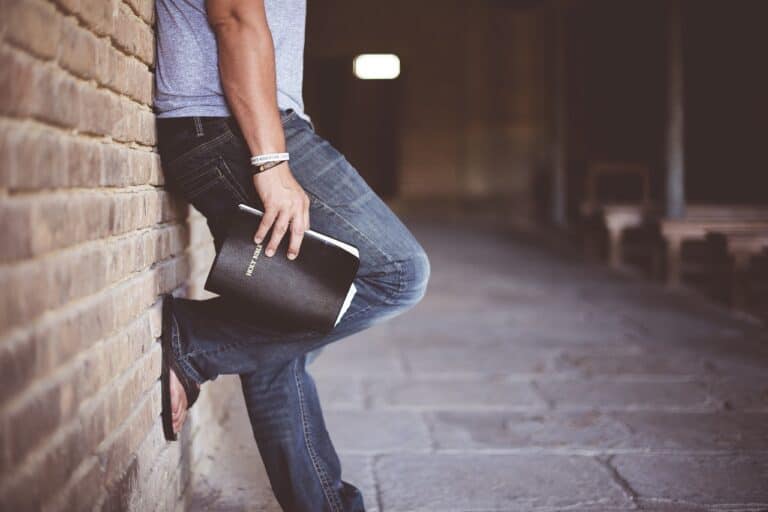 This man holding the Bible could use a guide on how to read the Bible for beginners