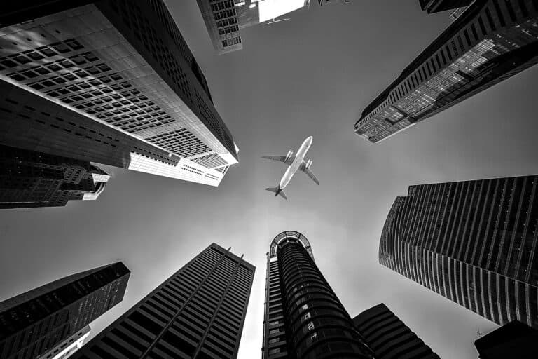 A plane flying over buildings in flyover country