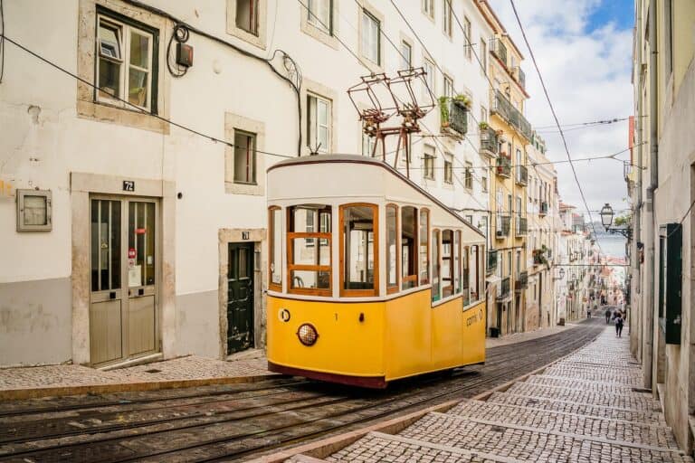 A tram on a narrow street in Lisbon, Portugal