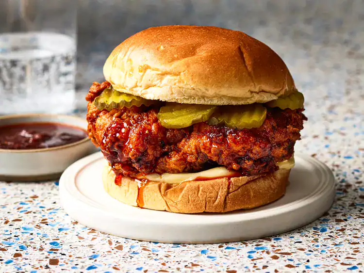Nashville hot chicken on a bun with pickles