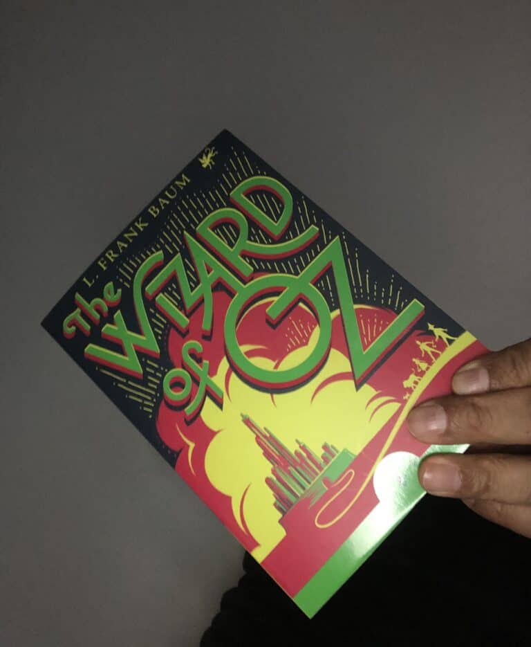 A man holding a copy of The Wizard of Oz