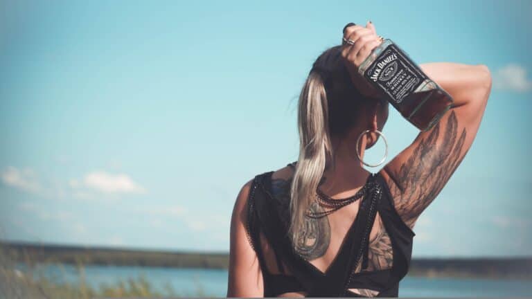 A woman holding a bottle of Tennessee whiskey